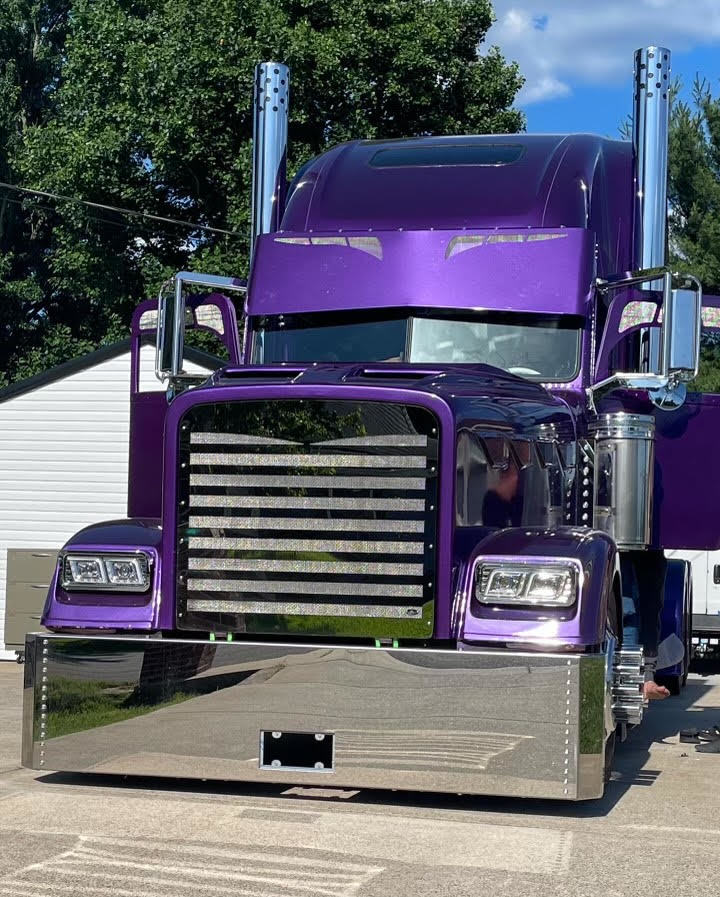 High-polish stainless steel custom bumper on a purple Peterbilt semi truck showing mirror finish and durability